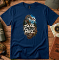 T-shirt featuring a bootprint framing a hiker, pine trees and mountain peaks