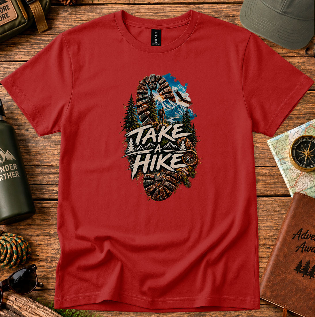 T-shirt featuring a bootprint framing a hiker, pine trees and mountain peaks