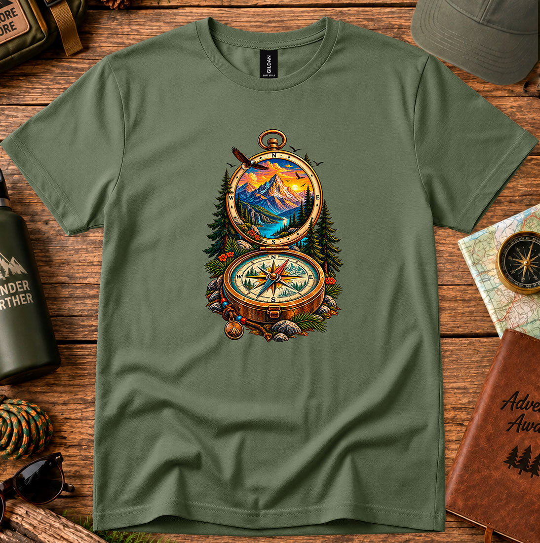 T-shirt featuring an open vintage compass framing a mountain lake and sunset
