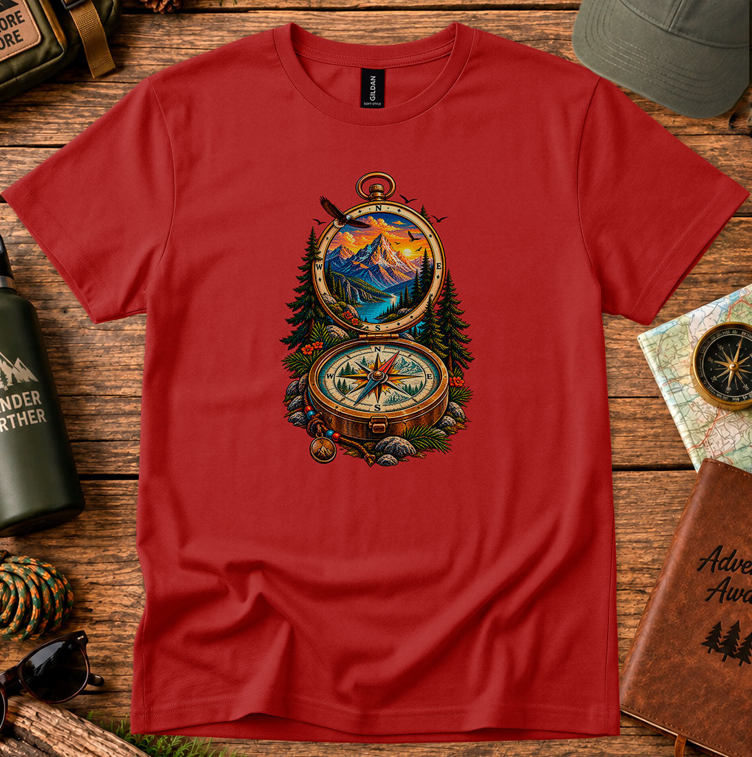 T-shirt featuring an open vintage compass framing a mountain lake and sunset