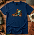 T-shirt featuring a detailed hiking boot graphic in warm forest tones