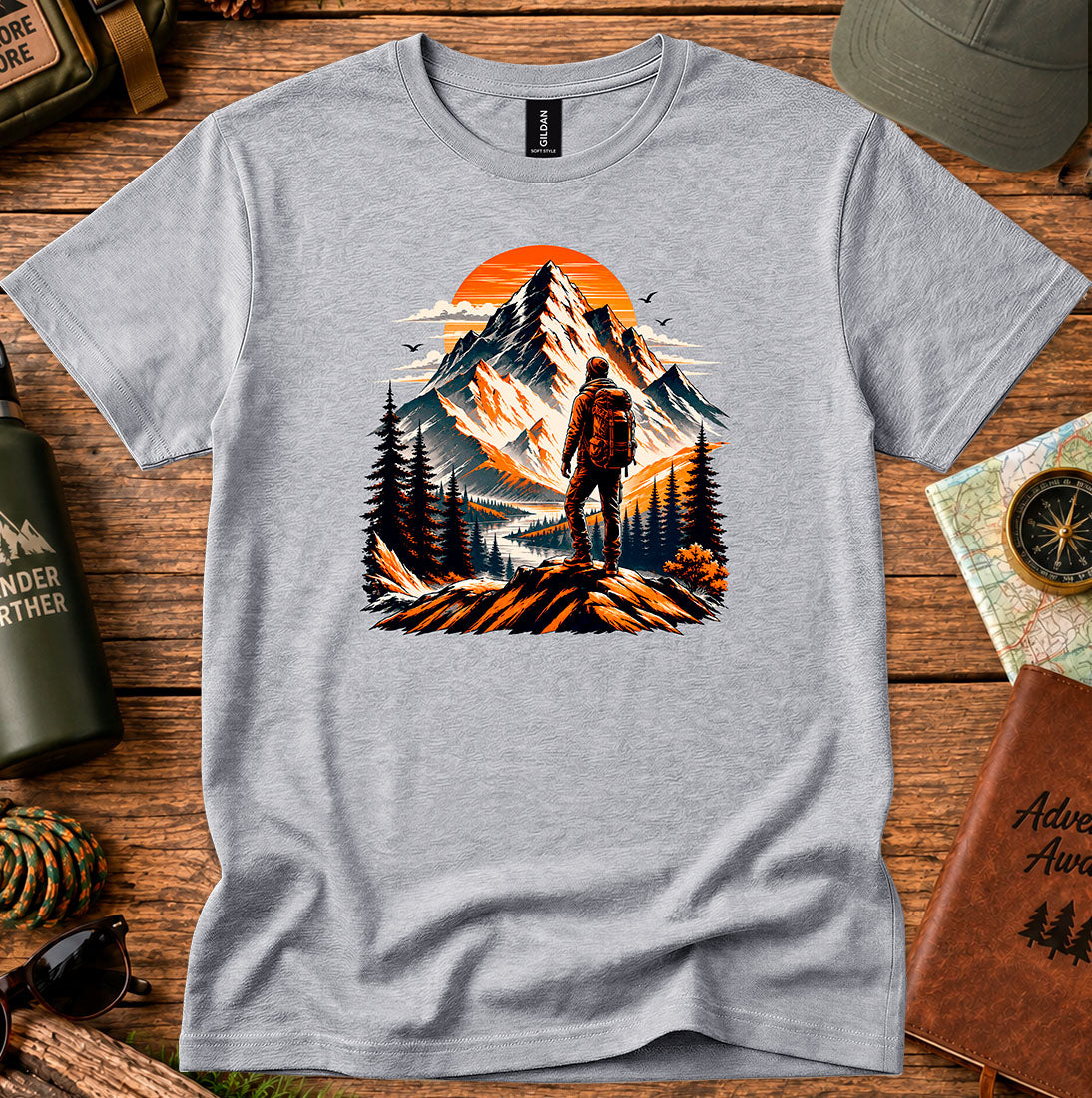 T-shirt featuring a lone hiker silhouetted against a glowing mountain sky