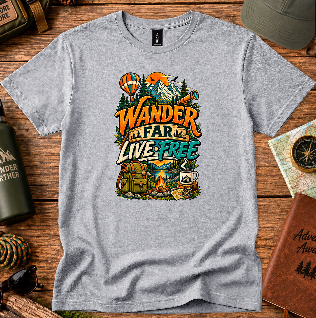 T-shirt featuring a mountain camp scene with a hot air balloon and campfire