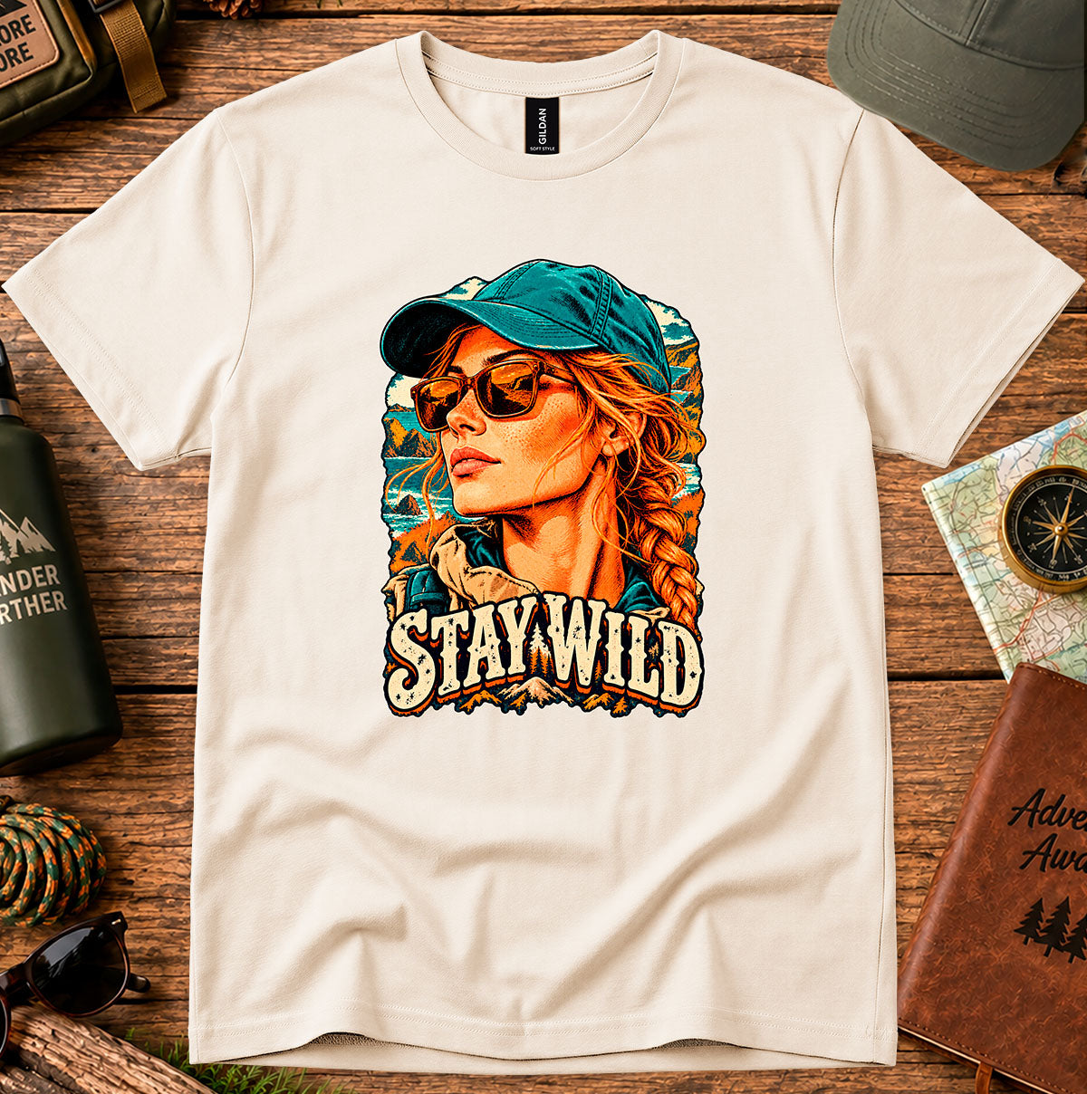 Stay Wild T-shirt with a retro portrait of a braided-haired woman wearing a cap and sunglasses