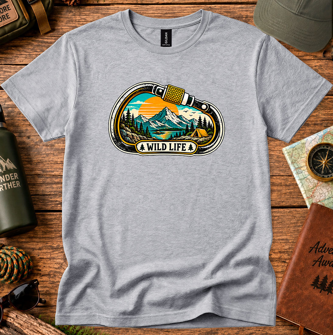 T-shirt featuring a carabiner framing mountain peaks, pine trees and a winding river
