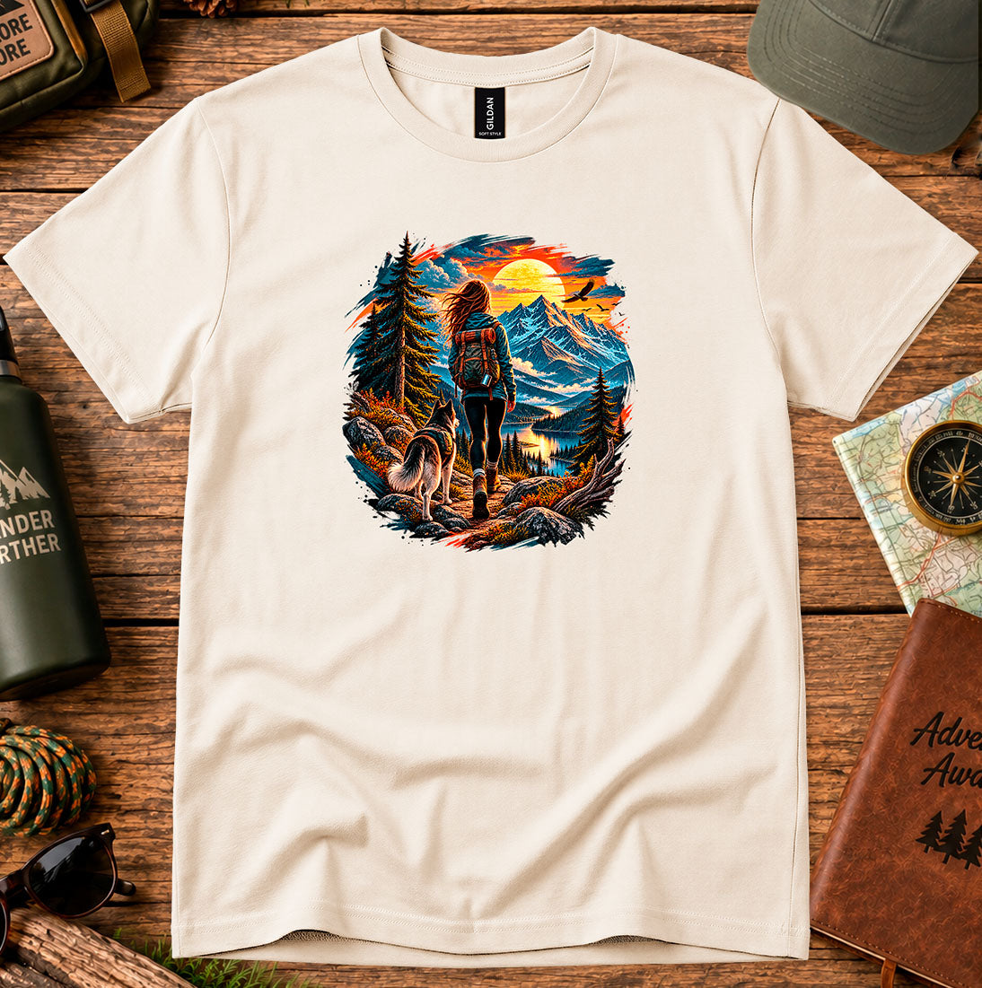 T-shirt featuring a hiker and dog beside a mountain lake at sunset