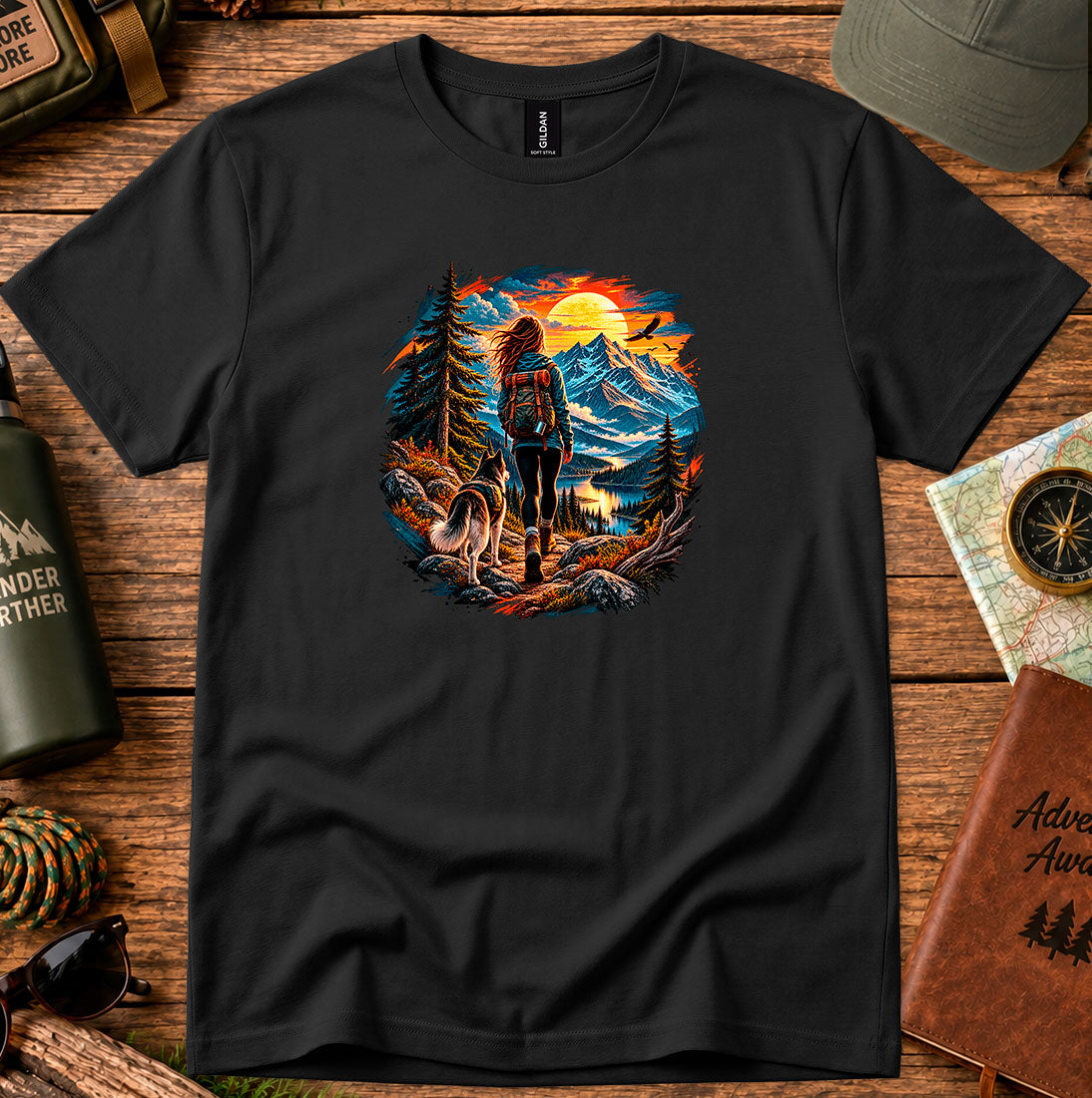 T-shirt featuring a hiker and dog beside a mountain lake at sunset