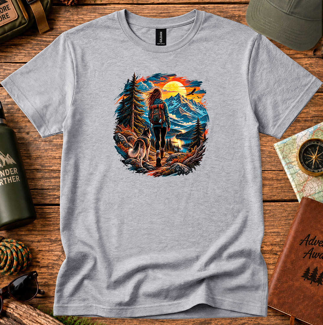 T-shirt featuring a hiker and dog beside a mountain lake at sunset